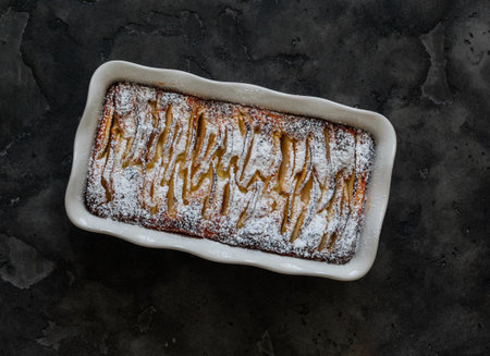 Cottage cheese apples cinnamon casserole - delicious breakfast, dessert on a dark background, top viewの写真素材