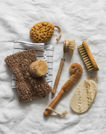 Kitchen accessories for cleaning and washing dishes - rags, napkins, brushes, sponges on a light background. view from aboveの写真素材
