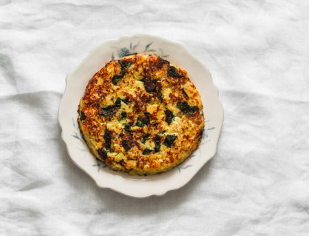 Potatoes, spinach, frittata cheese on a light background, top viewの写真素材
