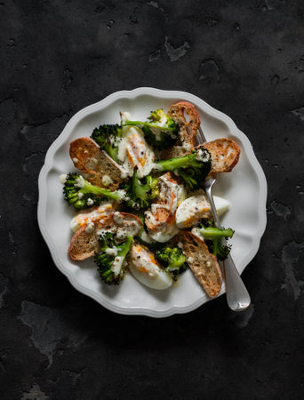 Alternative caesar salad with broccoli on a dark background, top viewの写真素材