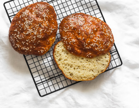 Gluten free cottage cheese flatbread with sesame seeds on a baking rack on a light background, top viewの写真素材