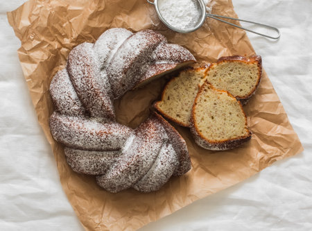 Slices of a traditional banana cake with powdered sugar on a light background, top viewの写真素材