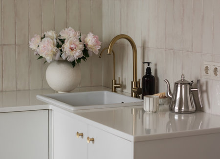 Cozy kitchen interior with a vase of peonies on the kitchen table. Minimalistic styleの写真素材