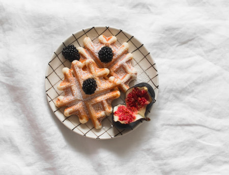 waffles served with figs and blackberries on a light background, top viewの写真素材