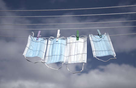 Medical masks catching fresh breath on a hanger.の写真素材