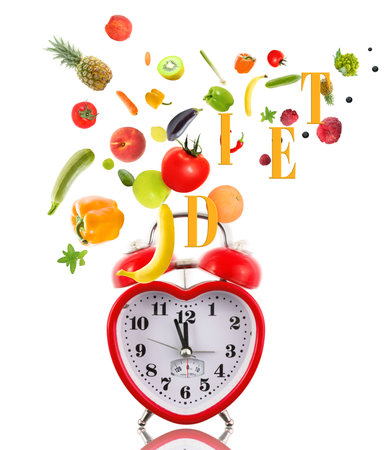 Clock in shape of heart with fruits and vegetables.の写真素材