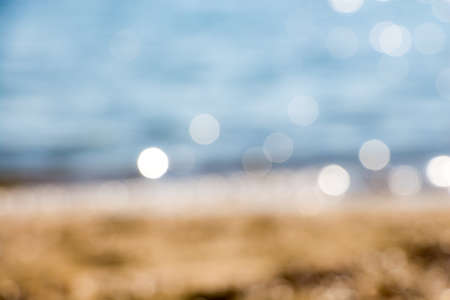 Abstract blue blur of seashore with bokehの写真素材