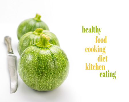 Three round zucchinis in a row with old knife and copy-spaceの写真素材