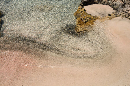 Wet sand washed by sea tide background の写真素材