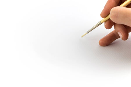 Hand holding brush, isolated on white backgroundの写真素材