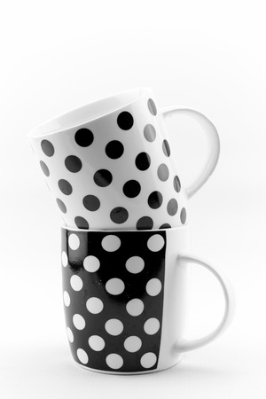 Black and white polka dots mugs isolated on white backgroundの写真素材