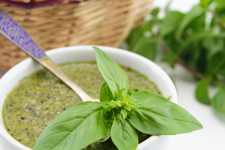 Pesto sauce and basil leaves closeupの写真素材