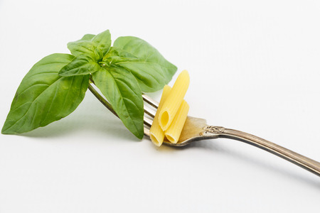 Basil leaves on fork, isolated on white backgroundの写真素材
