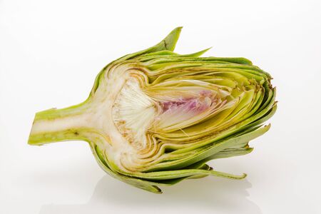 Fresh artichoke cut in half, isolated on white background.の写真素材