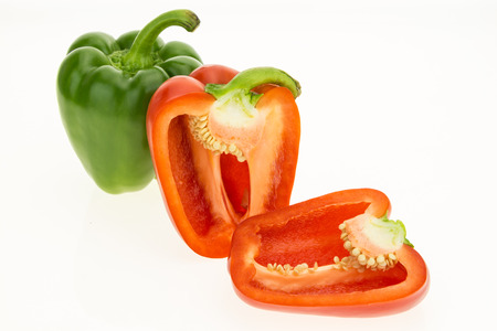 Fresh green and cut in half red bell peppers, isolated on white background.