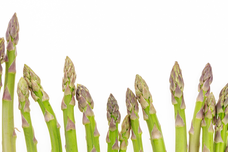 Bunch of asparagus tips on white background with copy-spaceの写真素材