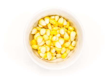 Corn kernels in a white bowl, on white background.の写真素材