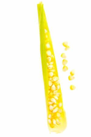 Corn kernels in leaf, on white background.