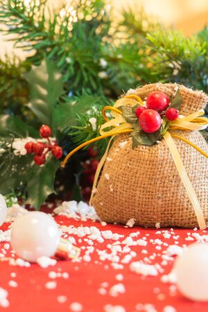 Christmas ornaments and snow, on red fabric.の写真素材