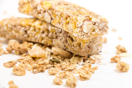 Granola energy bars with nuts and dry fruits, on white background.の写真素材