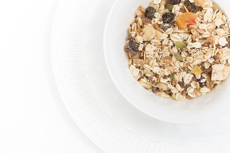 Bowl of muesli with dry fruits, on white,background.の写真素材