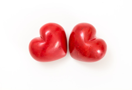 Two red hearts on white background.の写真素材