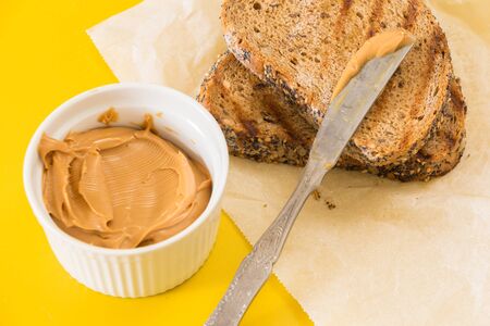 Spreading peanut butter on whole wheat grilled  bread slice
の写真素材