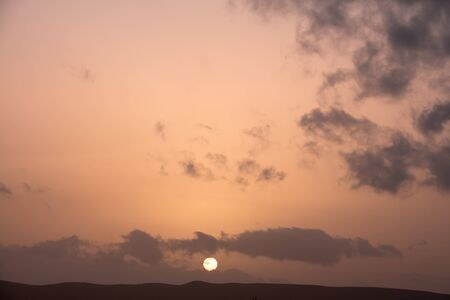 Colorful dawn/dusk sky with dark clouds background.の写真素材