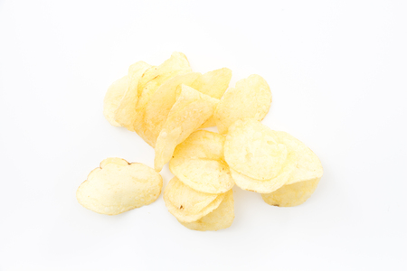 Crispy thinly sliced potato chips, on white background.の写真素材