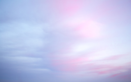 Colorful dawn/dusk sky, with pink and blue light clouds, background.の写真素材