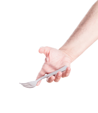 Hand holding fork, on white background.の写真素材