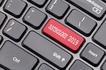 Astrology 2019 red on enter key, of a black keyboard.の写真素材