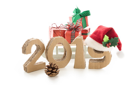 2019, handmade 3D numbers made of reused cardboard paper, with santa's red hat on nine and presents,...