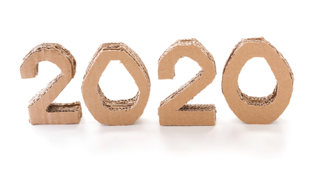 2020, handmade 3D numbers made of reused cardboard paper, on white background. New year...