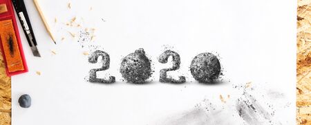 Hand drawn with pencil 2020 number, on white sketching paper, with pencil shavings and smudges. Creative New Year concept.の写真素材