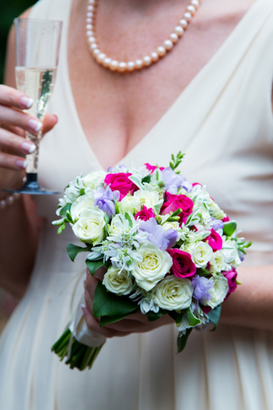 Bride holding beautiful white wedding flowers bouquetの写真素材