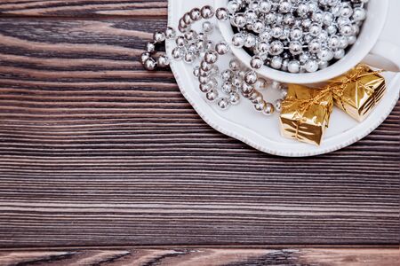 Cup of tea with christmas gifts.Top view, on a wooden backgroundの写真素材