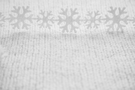 White snowflakes are on the knitted backgroundの写真素材