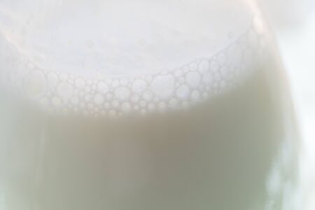 Milk foam on glass bottleの写真素材