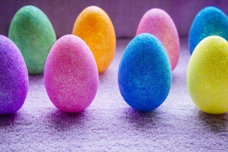 Colorful Easter Eggs on a fabric background. Creative concept