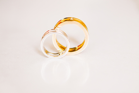 gold wedding rings on a white backgroundの写真素材