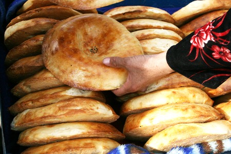 Uzbek national bread. Traditional eastern white flat bread baked in old stove.