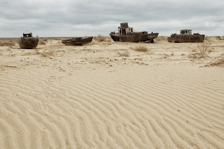 Old ships in the desert ship cemetery the consequence of Aral sea disaster, Muynak, Uzbekistanの写真素材