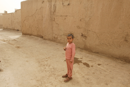 Khiva, Uzbekistan - March 08, 2009: Poverty in Uzbekistan. The boy is in pajamas and sandals that are large.のeditorial素材
