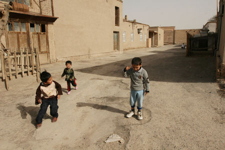 Khiva, Uzbekistan - March 08, 2009: Poverty in Uzbekistan. Children in the courtyard of the house play with themselves. No children's playgrounds. Everyday lifeのeditorial素材