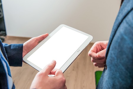 Close up of Man's hands working with digital tablet at business meeting for working concept,...