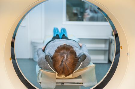 Close up patient at CT scan tomography in hospital, shot through the tube of device. Selective focusの写真素材