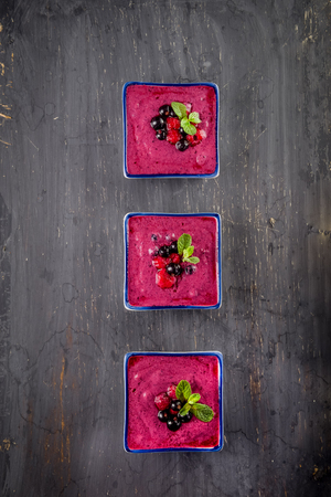 Top view Berry smoothie on black wooden background - Well being, Healthy eating, Detox or Diet concept. Selective focus, flat lay.の写真素材