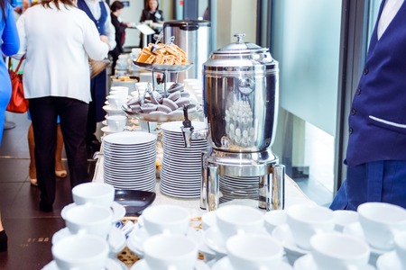 Catering table with dishes and snacks on the business event in the hotel hall. Close up, selective focusの写真素材