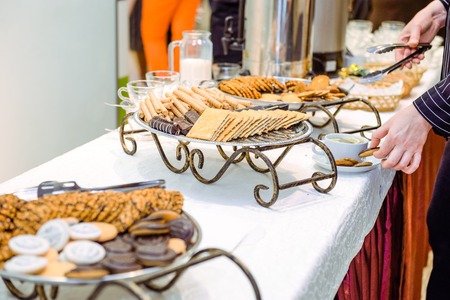 Catering table with dishes and snacks on the business event in the hotel hall. Close up, selective focusの写真素材
